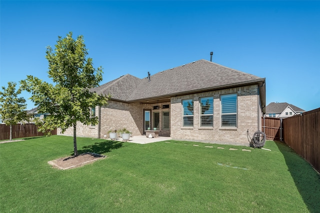 back of house featuring a yard and a patio area