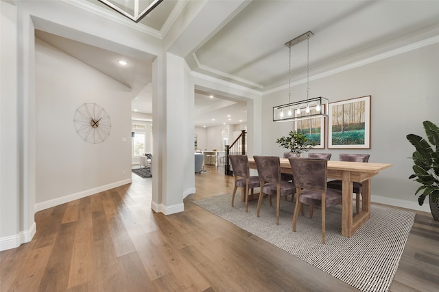 dining space with crown molding and hardwood / wood-style floors