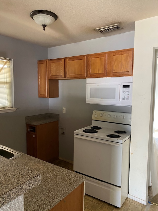 kitchen with white appliances and sink