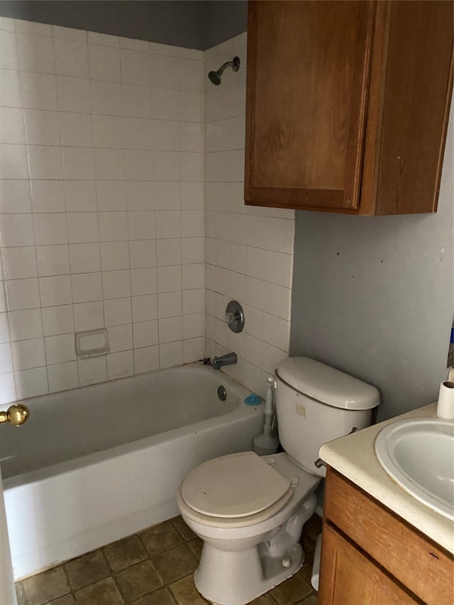 full bathroom with tile patterned flooring, vanity, toilet, and tiled shower / bath