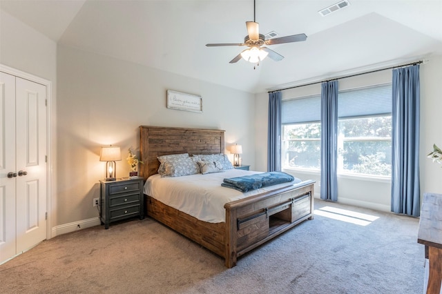 carpeted bedroom featuring lofted ceiling, a closet, and ceiling fan