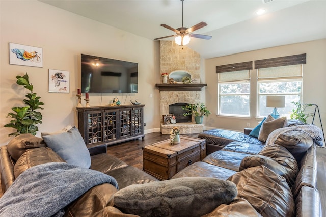 living room featuring dark wood-type flooring, ceiling fan, lofted ceiling, and a fireplace