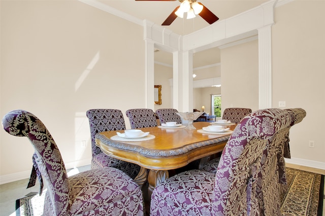 dining space featuring ceiling fan and crown molding