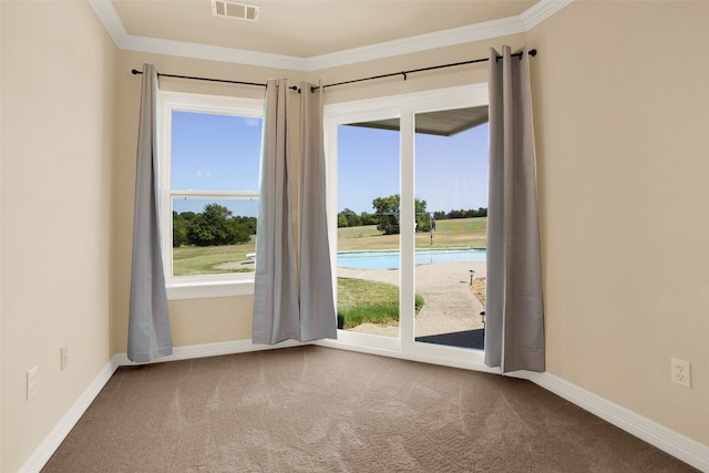 unfurnished room featuring a healthy amount of sunlight, carpet flooring, and crown molding