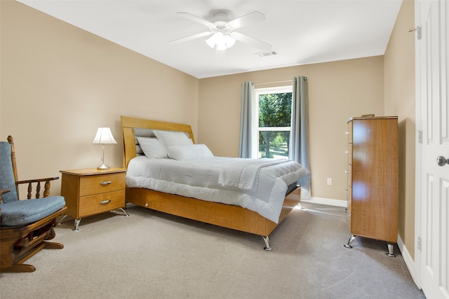 bedroom featuring light carpet and ceiling fan