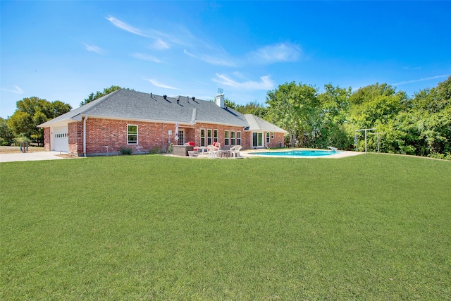 back of house featuring a yard and a patio area