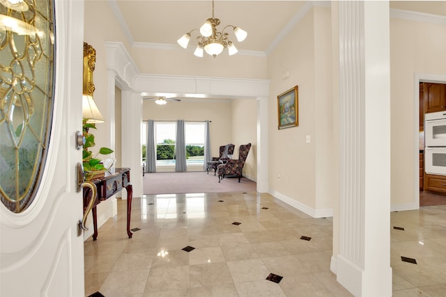 foyer with crown molding and ceiling fan with notable chandelier