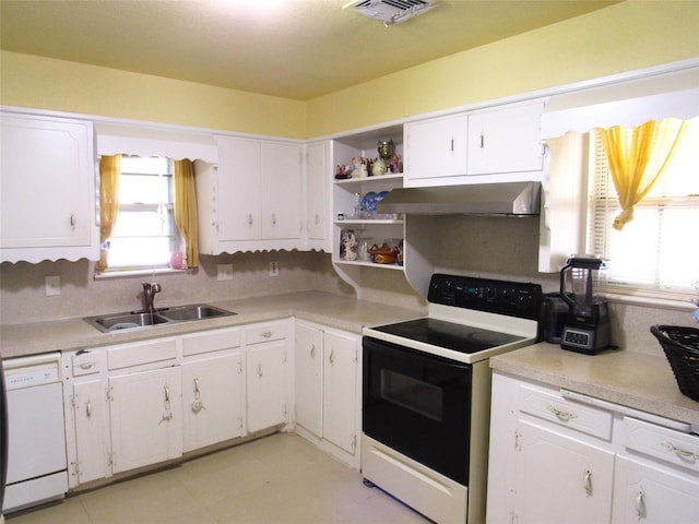 kitchen with white appliances, sink, and white cabinets