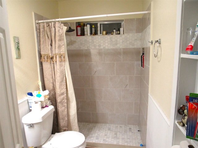 bathroom featuring toilet and a shower with shower curtain