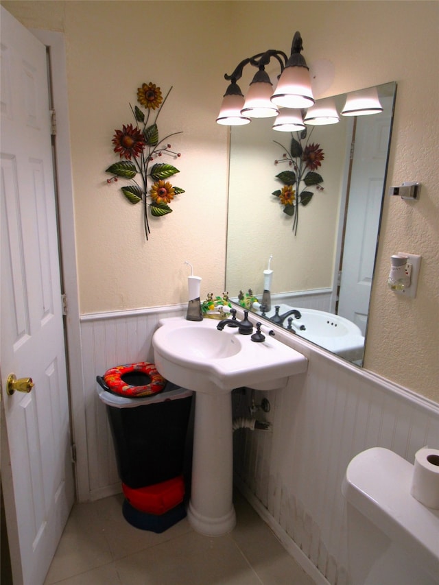 bathroom featuring sink, tile patterned floors, and toilet