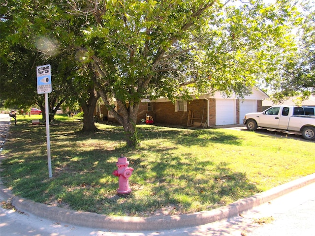 view of front facade featuring a garage and a front lawn