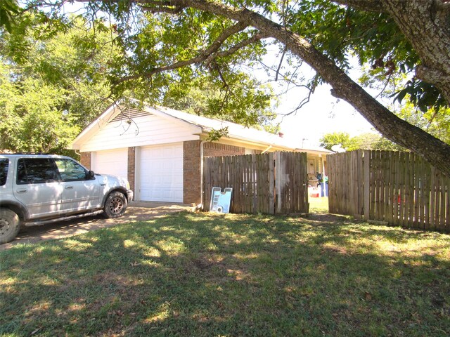 garage featuring a lawn