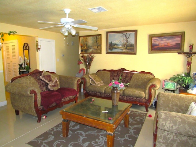 tiled living room with ceiling fan