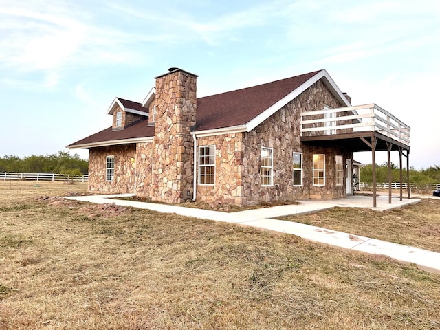 exterior space featuring a lawn, a patio, and a wooden deck