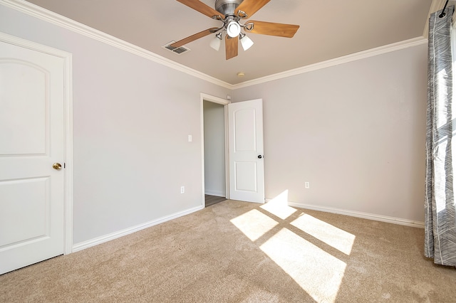 unfurnished bedroom with crown molding, ceiling fan, and light colored carpet