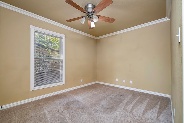 carpeted empty room featuring ornamental molding and ceiling fan