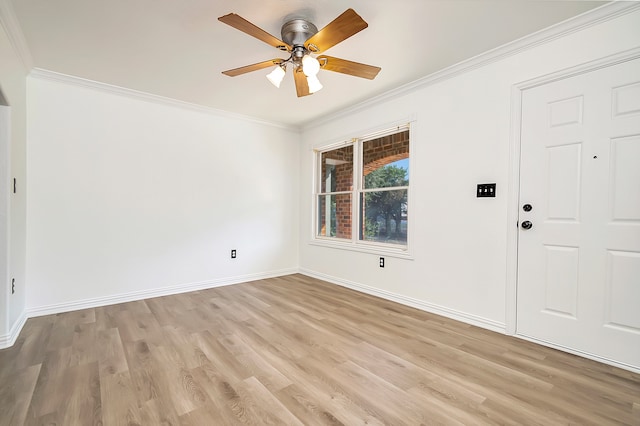 spare room with ceiling fan, light wood-type flooring, and crown molding