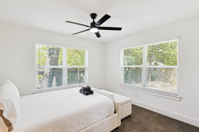 bedroom featuring dark carpet and ceiling fan