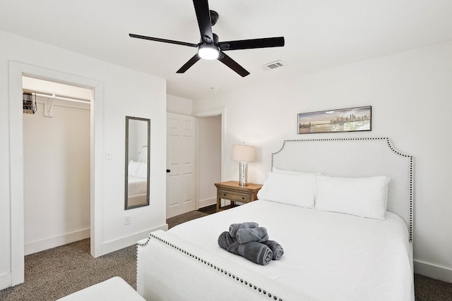 carpeted bedroom with ceiling fan and a closet