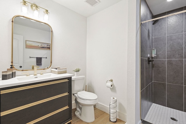 bathroom with vanity, toilet, wood-type flooring, and a shower with door