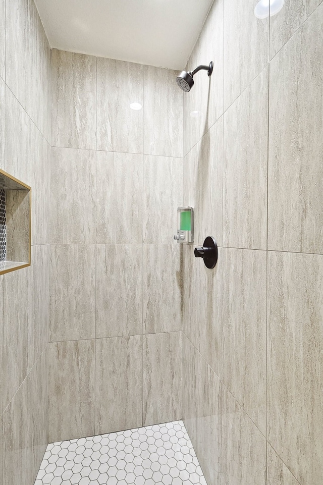 bathroom with a tile shower