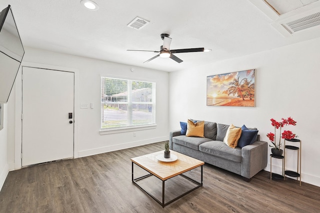 living room with ceiling fan and dark hardwood / wood-style flooring