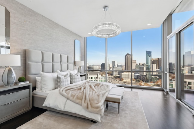 bedroom featuring a notable chandelier and floor to ceiling windows