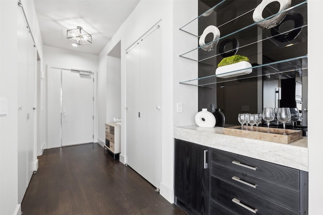 corridor with dark hardwood / wood-style flooring