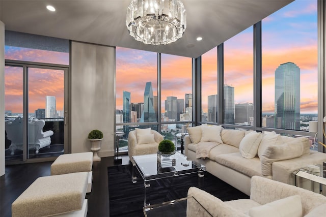 living room with a chandelier, a wall of windows, and hardwood / wood-style flooring