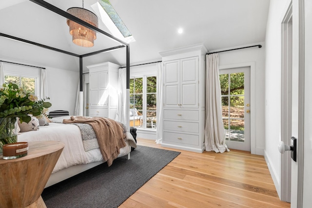 bedroom with multiple windows, access to outside, and light wood-type flooring