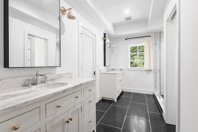 bathroom with vanity, a tray ceiling, tile patterned floors, and an enclosed shower