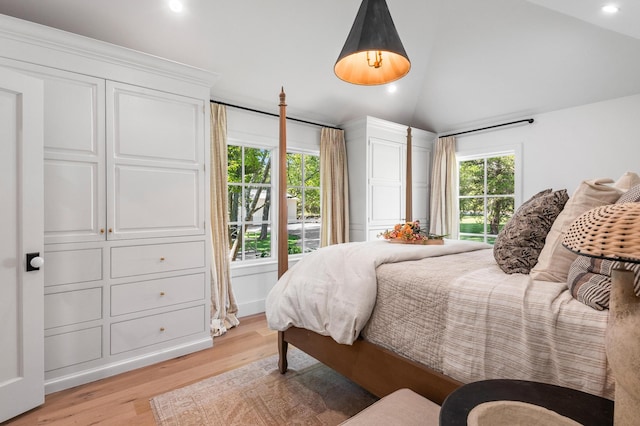 bedroom with lofted ceiling and light hardwood / wood-style flooring