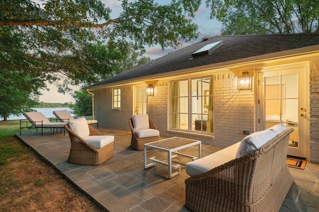 patio terrace at dusk featuring an outdoor hangout area