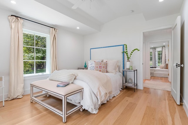 bedroom with multiple windows, light hardwood / wood-style floors, and ceiling fan