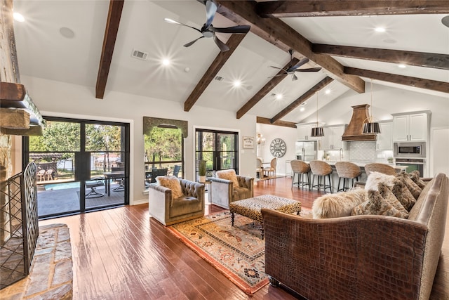 living room with beam ceiling, ceiling fan, dark hardwood / wood-style floors, and plenty of natural light