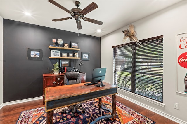 home office with ceiling fan and dark hardwood / wood-style flooring