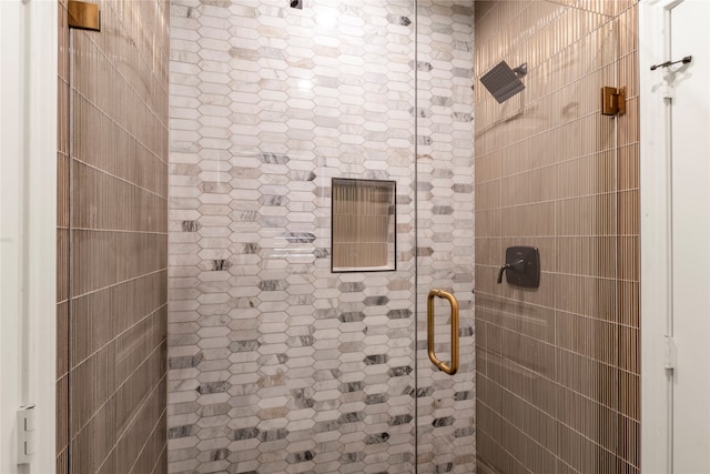 bathroom with a shower with shower door