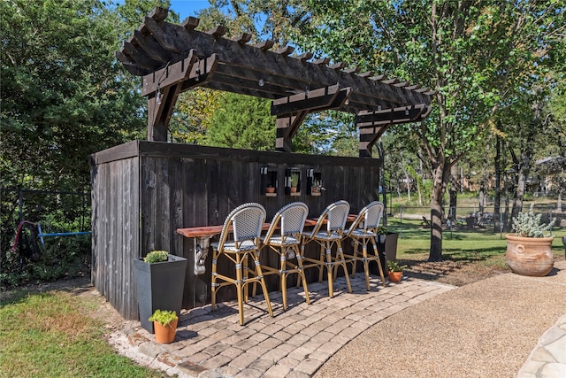 view of patio with a pergola and a bar