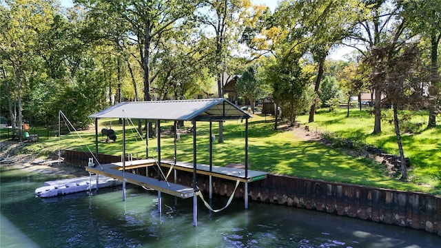 dock area featuring a lawn and a water view