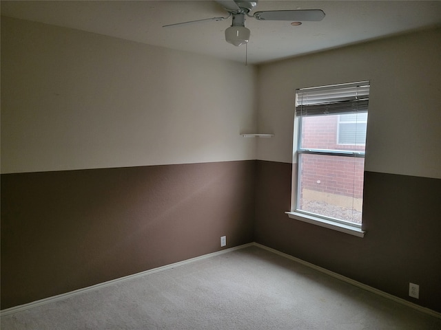 empty room featuring carpet floors and ceiling fan