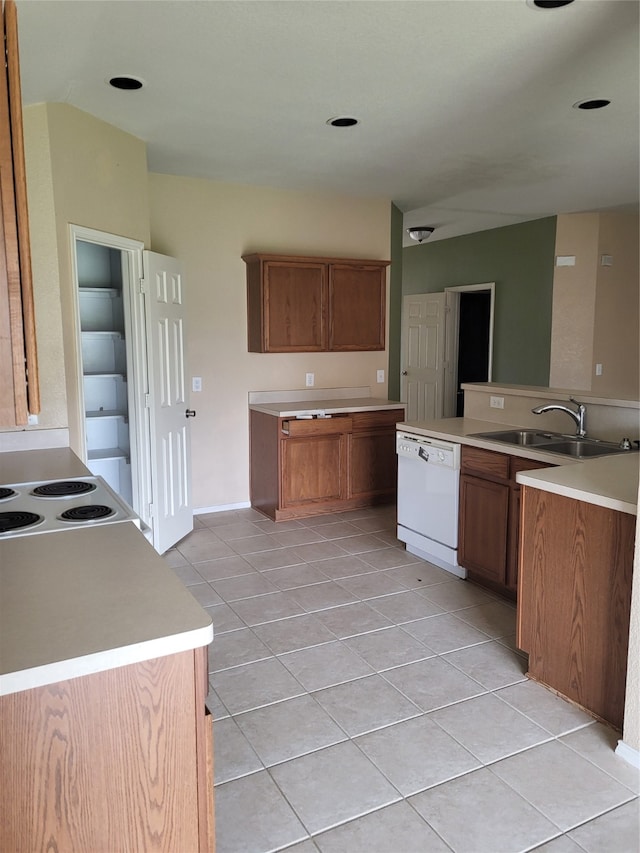 kitchen featuring white appliances, sink, and light tile patterned floors