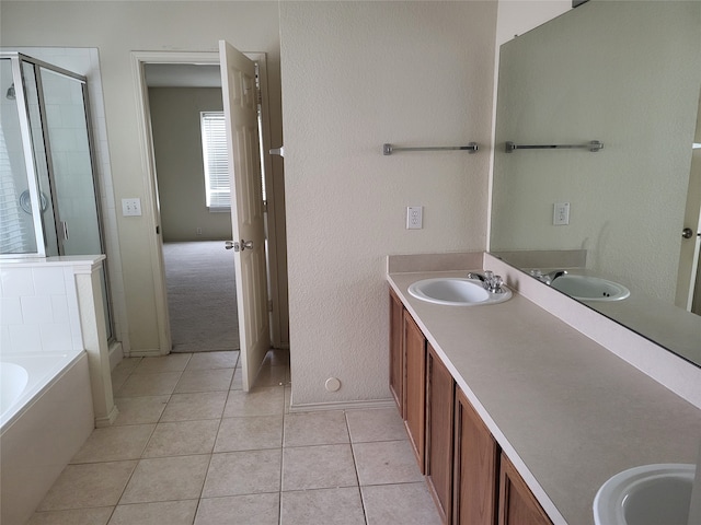 bathroom with independent shower and bath, vanity, and tile patterned floors