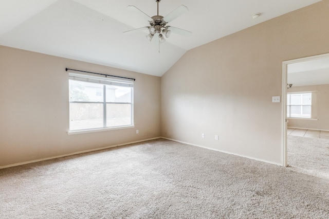 carpeted empty room with ceiling fan and lofted ceiling