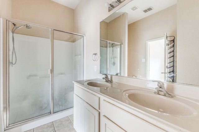 bathroom featuring vanity, a shower with door, and tile patterned floors