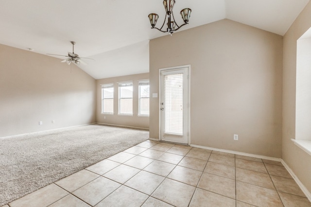 unfurnished room featuring ceiling fan with notable chandelier, lofted ceiling, and light colored carpet