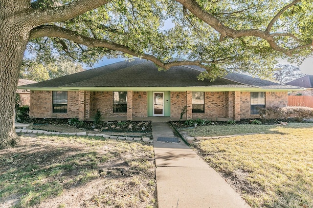 ranch-style home with a front lawn