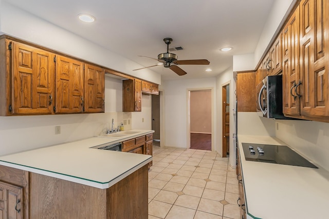 kitchen featuring sink, light tile patterned floors, dishwashing machine, kitchen peninsula, and ceiling fan