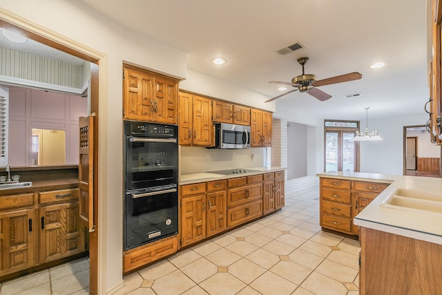 kitchen with ceiling fan, sink, hanging light fixtures, and black appliances