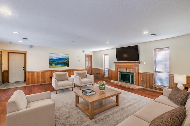 living room with a brick fireplace and light hardwood / wood-style flooring