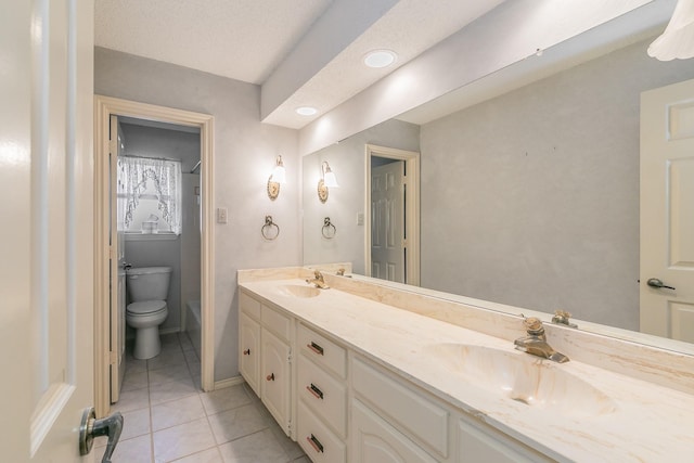 bathroom featuring vanity, tile patterned floors, and toilet